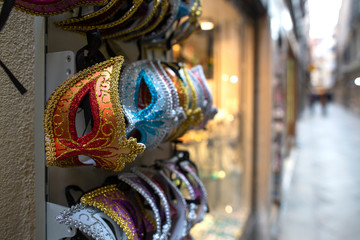 Fototapeta na wymiar Many Colorful Venetian Style Masks Souvenirs in Venice, Italy. masks at a souvenir shop in the street of Venice, Italy. Masks have always been an important feature of the famous Venetian carnival.