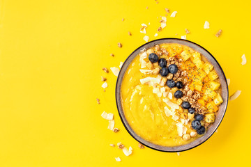 Top view of mango smoothie bowl with fruits