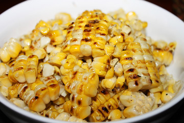 Close-up of grilled corn in a white bowl