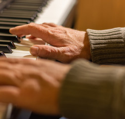 Playing Piano. Pianist with Hands on Keys Close-up.