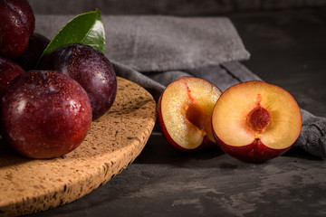 Red plums in a cork plate
