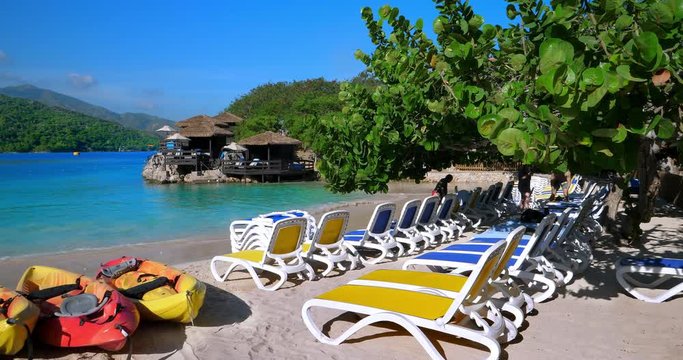 Tropical beach waiting for tourists from the "Harmony Of The Seas" Royal Caribbean cruise ship during summer vacation in Labadee, Haiti, 4K