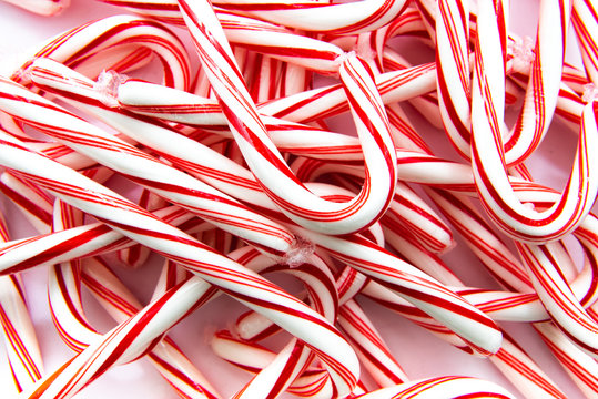 A Pile Of Peppermint Red And White Candy Canes, A Holiday Favorite.