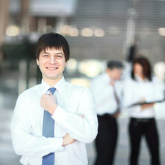 portrait of a successful young employee on blurred background office