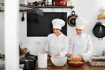 Female chefs preparing food on restaurant kitchen