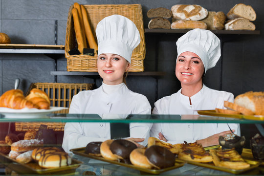Female cooks demonstrating and selling pastry in the cafe