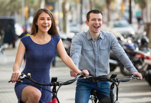 Young couple with electric bikes .