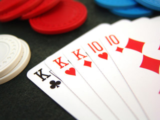 Poker full  house hand with poker chips