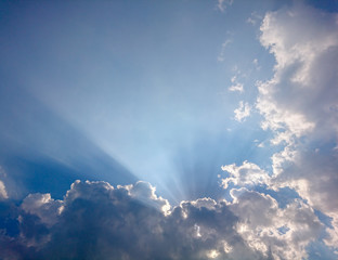 Fototapeta na wymiar Clouds in blue sky with rays of light