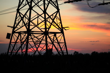 In the evening, the silhouette of high voltage towers