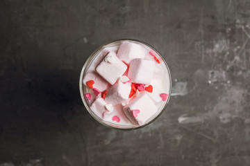 Hot sweet milk with pink marshmallows. Selective focus. Shallow depth of field.