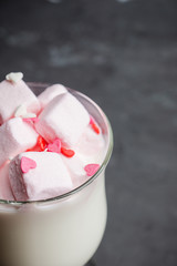Hot sweet milk with pink marshmallows. Selective focus. Shallow depth of field.