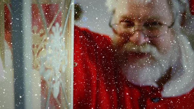 Video composition with falling snow over santa holding lattern