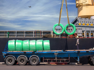 The vessel discharging steel wire rods on truck at industrial port of thailand.