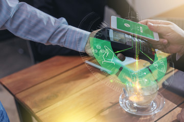 Businessman paying with NFC technology by smartphone in coffee shop. mobile payment concept