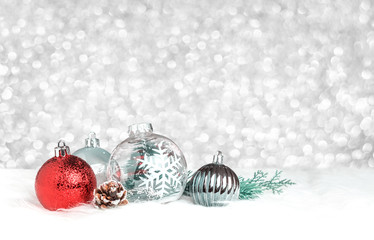 Christmas decoration ball on white fur at silver bokeh light background,Holiday greeting card