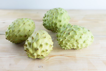 Annona, Custard Apple, Cherimoya, Sugar Apple. Woman Hands Holding Annona Fruit on White Background.