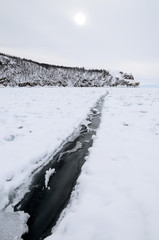 Narrow crack in ice of Lake Baikal