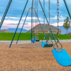 Close up of blue swing connected to a metal chain