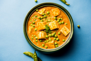 Green peas or matar paneer curry recipe, served in a bowl. selective focus