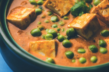 Green peas or matar paneer curry recipe, served in a bowl. selective focus