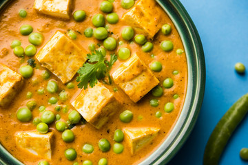 Green peas or matar paneer curry recipe, served in a bowl. selective focus