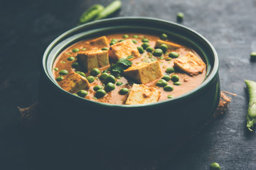 Green peas or matar paneer curry recipe, served in a bowl. selective focus