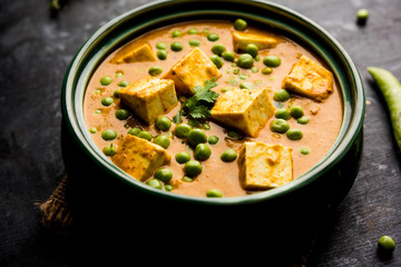 Green peas or matar paneer curry recipe, served in a bowl. selective focus