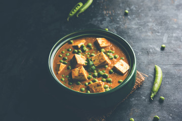 Green peas or matar paneer curry recipe, served in a bowl. selective focus