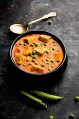 Green peas or matar paneer curry recipe, served in a bowl. selective focus