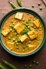 Green peas or matar paneer curry recipe, served in a bowl. selective focus