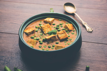 Green peas or matar paneer curry recipe, served in a bowl. selective focus