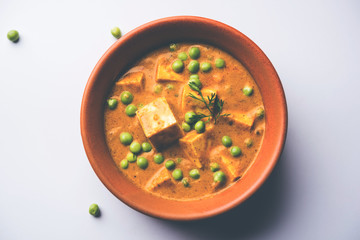 Green peas or matar paneer curry recipe, served in a bowl. selective focus