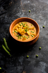 Green peas or matar paneer curry recipe, served in a bowl. selective focus