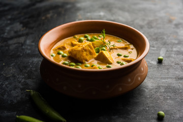 Green peas or matar paneer curry recipe, served in a bowl. selective focus