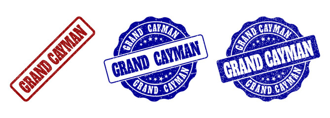 GRAND CAYMAN grunge stamp seals in red and blue colors. Vector GRAND CAYMAN signs with grunge surface. Graphic elements are rounded rectangles, rosettes, circles and text captions.