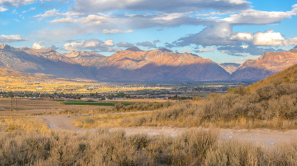 Dirt road leading to homes in sunny Utah Valley
