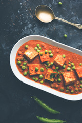 Green peas or matar paneer curry recipe, served in a bowl. selective focus