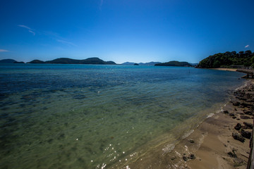 Background of the sea, blue sky wallpaper, the beauty of nature in bright weather, green water looks refreshing.