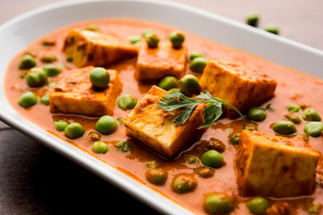 Green peas or matar paneer curry recipe, served in a bowl. selective focus