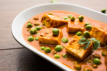 Green peas or matar paneer curry recipe, served in a bowl. selective focus