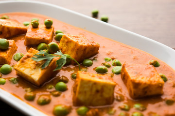 Green peas or matar paneer curry recipe, served in a bowl. selective focus