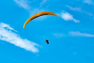 paraglider on the background of bright blue sky