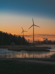 Windmills in the forest during a beautiful red sunset in Finland