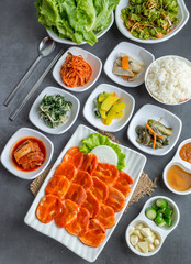 Set of slice raw pork ready to grill korean style, include slide food with vegetable and rice.