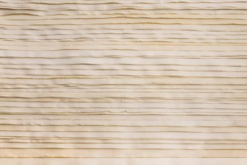 Stack of old yellowed paper, closeup view. Texture with horizontal lines of paper.