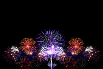 Group of colorful fireworks on dark background.