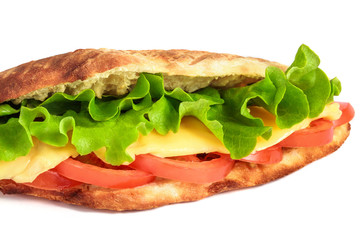 Sandwich from fresh pita bread with lettuce, slices of fresh tomatoes, ham pork and cheese on white background