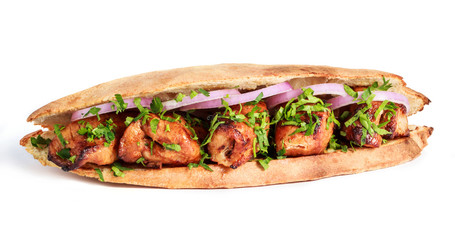 Grilled meat in sandwich with onion and greens on white background. Shashlik or Shish kebab popular in Eastern Europe. Hot meat dishes