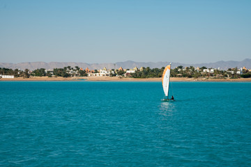 Sailboat in the sea near the island.